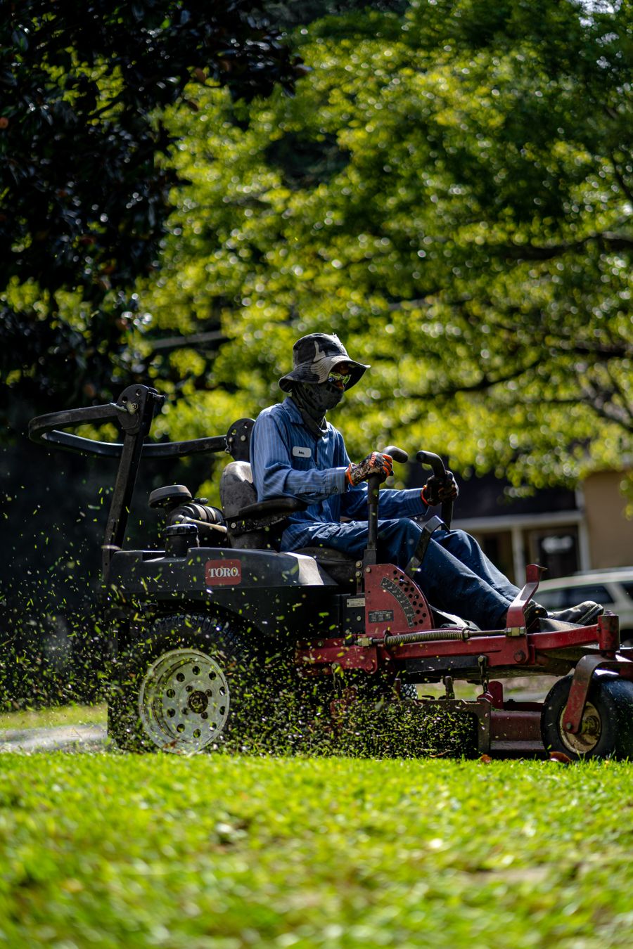 Landscaping professional mowing a lawn